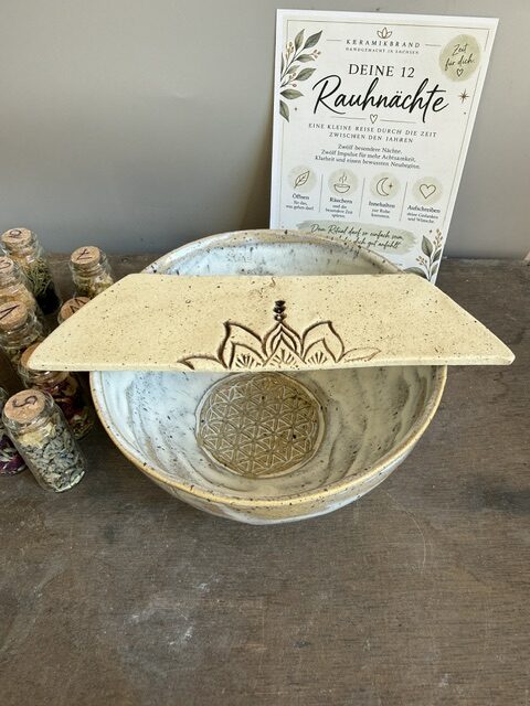 Handgemachte Keramik und Räuchern verbinden Natur, traditionelles Handwerk und bewusste Achtsamkeit. In der Keramikbrand-Werkstatt im sächsischen Erzgebirge entstehen mit viel Liebe zum Detail einzigartige Räucherschalen, Keramikbecher und Ritualplatten mit Symbolen wie der Lotusblüte und der Blume des Lebens. Ob für persönliche Räucherrituale, die acht Jahreskreisfeste oder kleine Auszeiten im Alltag – handgefertigte Keramik begleitet besondere Momente und schafft Raum für Ruhe, Dankbarkeit und Naturverbundenheit. Entdecke, wie einfache Rituale mit Keramik, Kräutern und Kerzen zu einer persönlichen Tradition werden können.